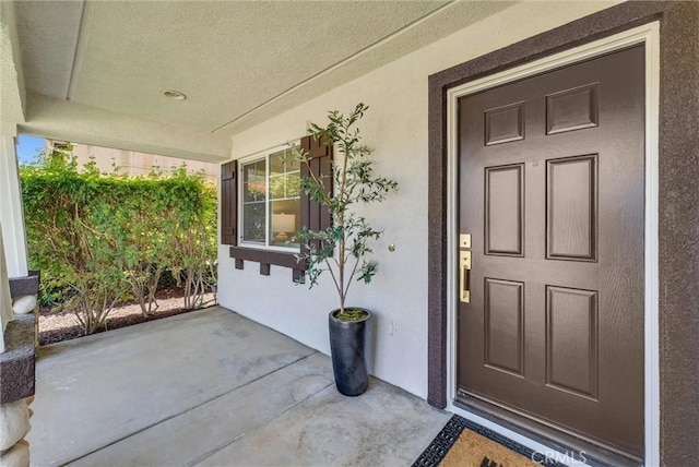 46079 Galaxy Ct, Temecula, CA 92592 - doorway to property with stucco siding and a porch