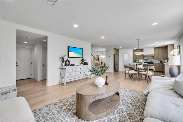 46079 Galaxy Ct, Temecula, CA 92592 - living room featuring stairs, light wood finished floors, and recessed lighting