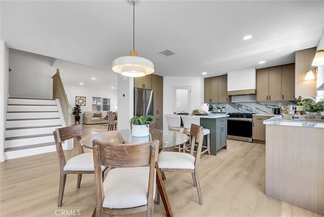 46079 Galaxy Ct, Temecula, CA 92592 - dining area with light wood-style flooring, recessed lighting, and stairway