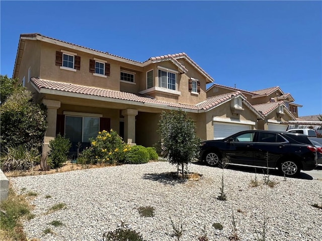 12839 Fencerider Way, Victorville, CA 92392 - view of front of house featuring stucco siding, a tile roof, an attached garage, and driveway