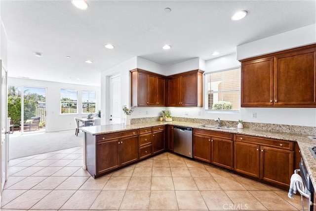 61 Via Almeria, San Clemente, CA 92673 - kitchen featuring dishwasher, a peninsula, light stone counters, light tile patterned floors, and light colored carpet