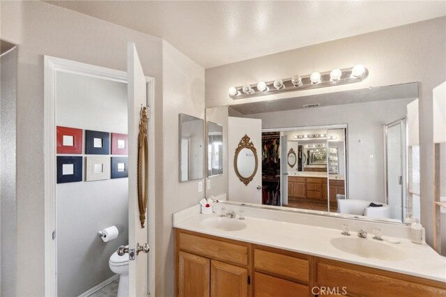 25880 Jumano Dr, Moreno Valley, CA 92551 - full bathroom featuring double vanity and toilet