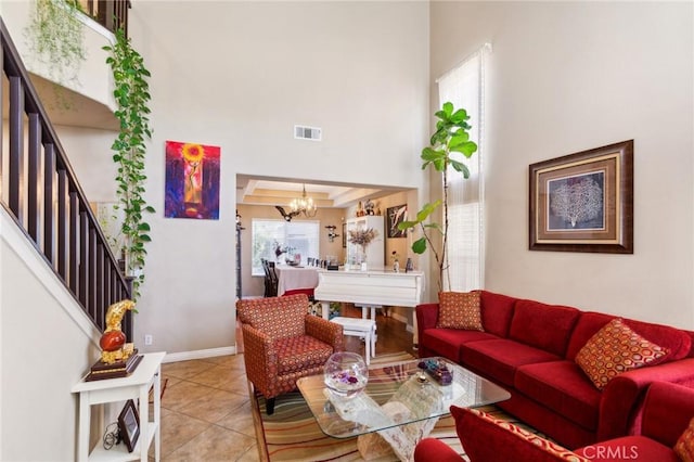 25880 Jumano Dr, Moreno Valley, CA 92551 - tiled living area featuring a chandelier, a towering ceiling, and stairway
