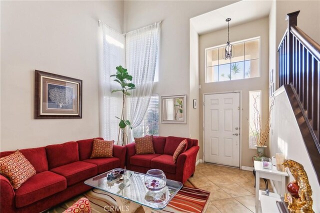 25880 Jumano Dr, Moreno Valley, CA 92551 - living room featuring a high ceiling, light tile patterned flooring, and stairway
