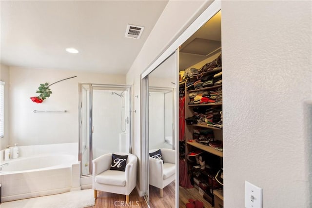 25880 Jumano Dr, Moreno Valley, CA 92551 - full bathroom with a stall shower, a garden tub, wood finished floors, and a walk in closet