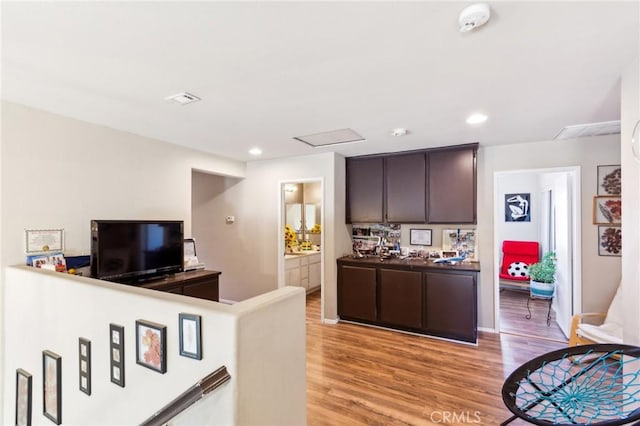 25880 Jumano Dr, Moreno Valley, CA 92551 - kitchen with dark brown cabinets, light wood-style floors, and recessed lighting
