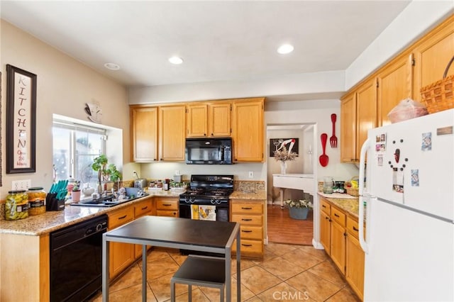 25880 Jumano Dr, Moreno Valley, CA 92551 - kitchen with black appliances, light tile patterned floors, recessed lighting, and light stone counters
