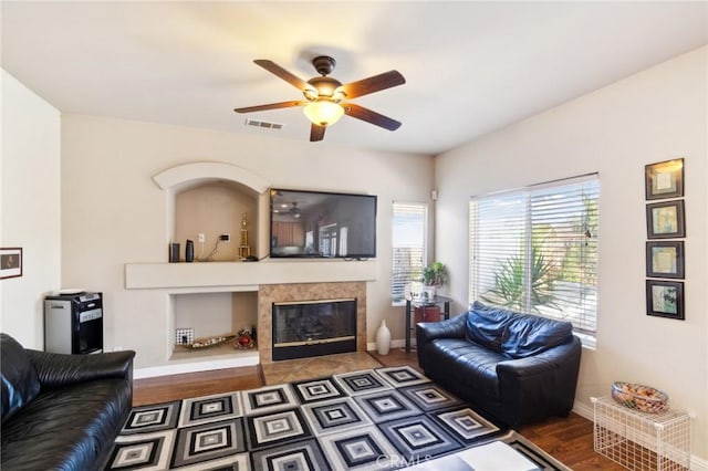 25880 Jumano Dr, Moreno Valley, CA 92551 - living area featuring ceiling fan, wood finished floors, and a tiled fireplace