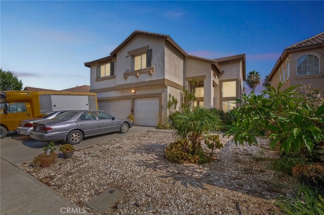 25880 Jumano Dr, Moreno Valley, CA 92551 - view of front of house with driveway, a garage, and stucco siding