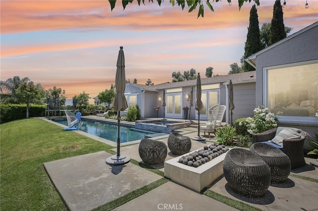 2211 N Moody Ave, Fullerton, CA 92831 - pool at dusk featuring a patio area, a lawn, french doors, and a pool with connected hot tub