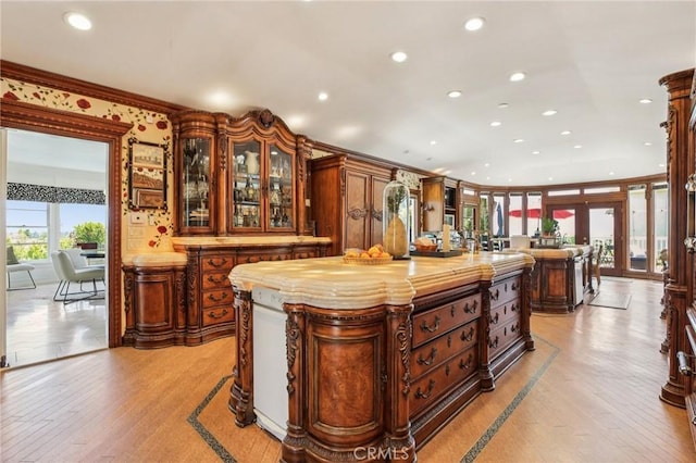 2211 N Moody Ave, Fullerton, CA 92831 - kitchen featuring recessed lighting, crown molding, light wood finished floors, a kitchen island, and glass insert cabinets