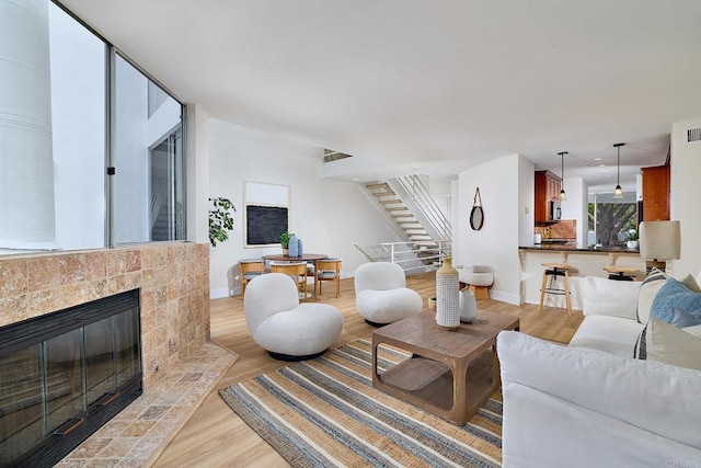 159 Mozart Ave, Cardiff By The Sea, CA 92007 - living room with stairway, light wood-style flooring, recessed lighting, and a fireplace