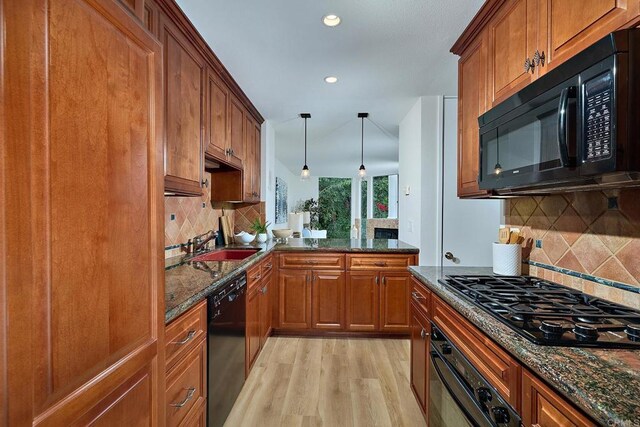 159 Mozart Ave, Cardiff By The Sea, CA 92007 - kitchen featuring black appliances, light wood finished floors, brown cabinets, decorative backsplash, and dark stone countertops