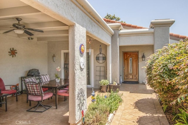 5521 Via La Mesa Unit C, Laguna Woods, CA 92637 - entrance to property with outdoor dining area, ceiling fan, stucco siding, a patio area, and a tiled roof