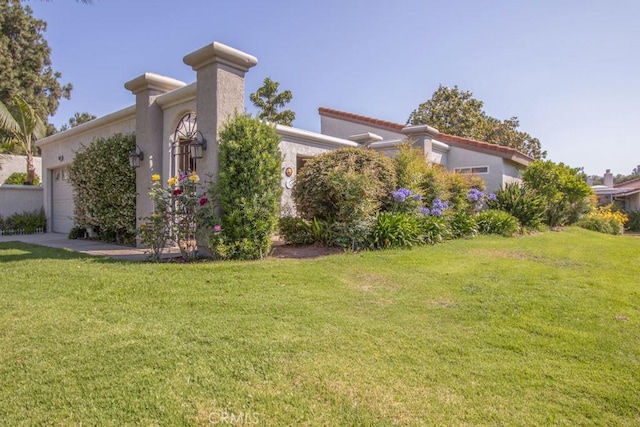 5521 Via La Mesa Unit C, Laguna Woods, CA 92637 - view of side of home with an attached garage, a lawn, and stucco siding