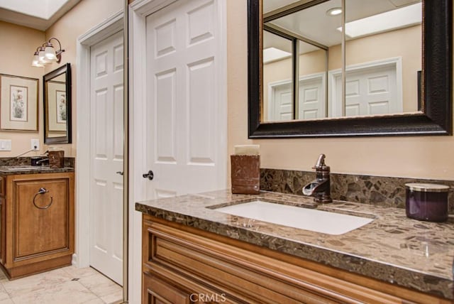 5521 Via La Mesa Unit C, Laguna Woods, CA 92637 - bathroom with vanity, marble finish floors, and a skylight