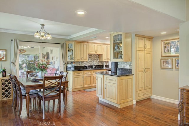5521 Via La Mesa Unit C, Laguna Woods, CA 92637 - kitchen featuring light brown cabinetry, dark countertops, a chandelier, decorative backsplash, and crown molding