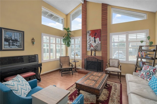 339 W Dawson Ct, Glendora, CA 91740 - living area with high vaulted ceiling, plenty of natural light, wood finished floors, and a brick fireplace