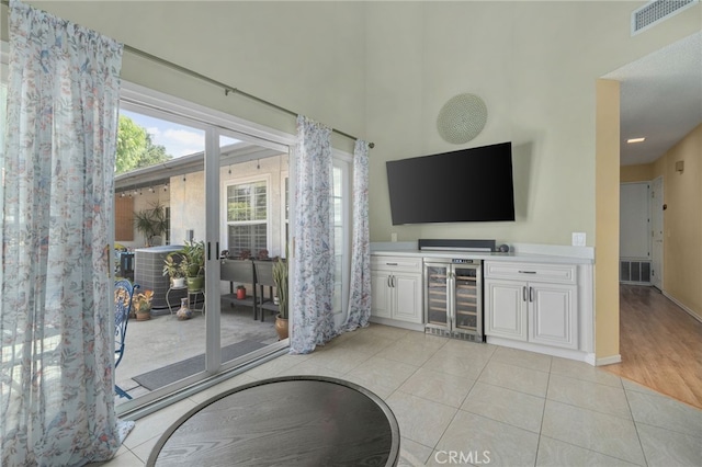 339 W Dawson Ct, Glendora, CA 91740 - living room with beverage cooler, light tile patterned floors, a bar, and a high ceiling