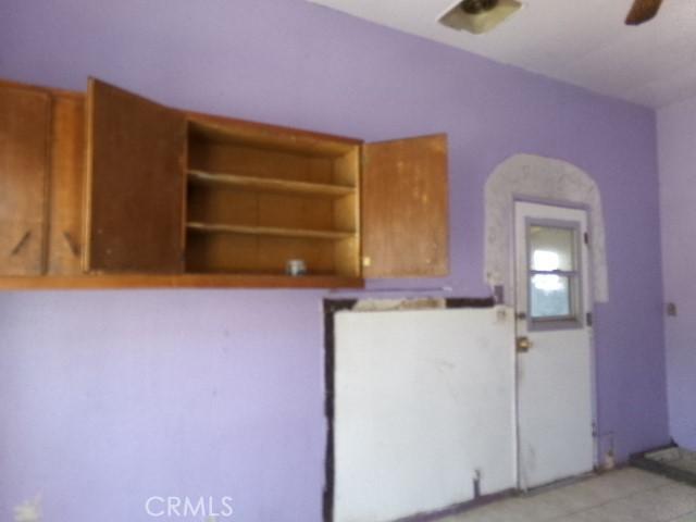 34915 Cedar Rd, Barstow, CA 92311 - kitchen featuring a ceiling fan and brown cabinets