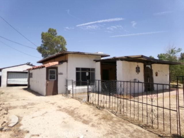 34915 Cedar Rd, Barstow, CA 92311 - view of front of property featuring stucco siding and a detached garage