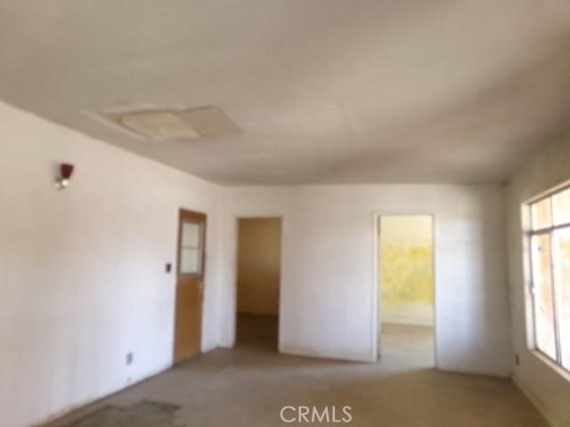 34915 Cedar Rd, Barstow, CA 92311 - spare room featuring light colored carpet and healthy amount of natural light