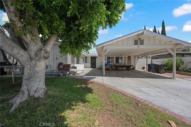 8894 Riverside, Riverside, CA 92503 - back of property featuring concrete driveway, board and batten siding, and a carport