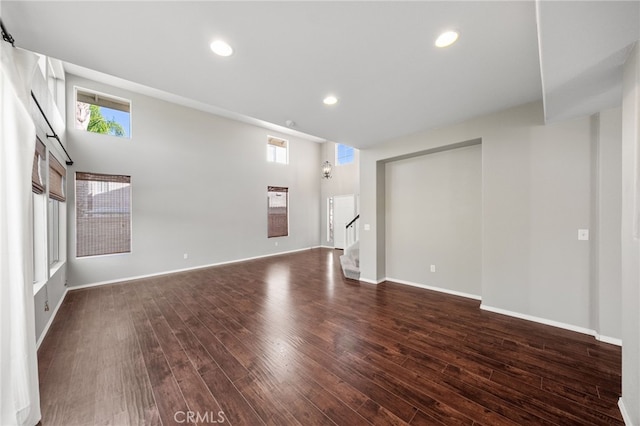 45114 Via Quivera, Temecula, CA 92592 - spare room featuring dark wood-type flooring, stairway, and recessed lighting