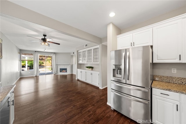 45114 Via Quivera, Temecula, CA 92592 - kitchen with stainless steel fridge, open floor plan, ceiling fan, a fireplace, and white cabinetry