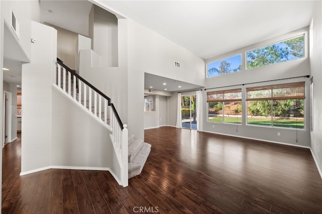 45114 Via Quivera, Temecula, CA 92592 - unfurnished living room featuring a towering ceiling, wood finished floors, and stairs