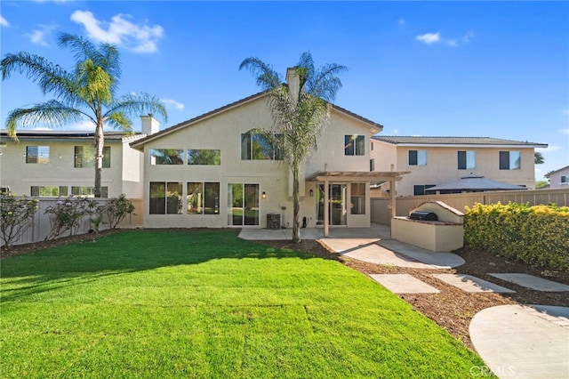 45114 Via Quivera, Temecula, CA 92592 - back of house featuring a pergola, a fenced backyard, a patio, stucco siding, and exterior kitchen