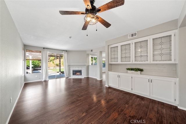 45114 Via Quivera, Temecula, CA 92592 - unfurnished living room featuring dark wood-type flooring, a fireplace with flush hearth, and ceiling fan