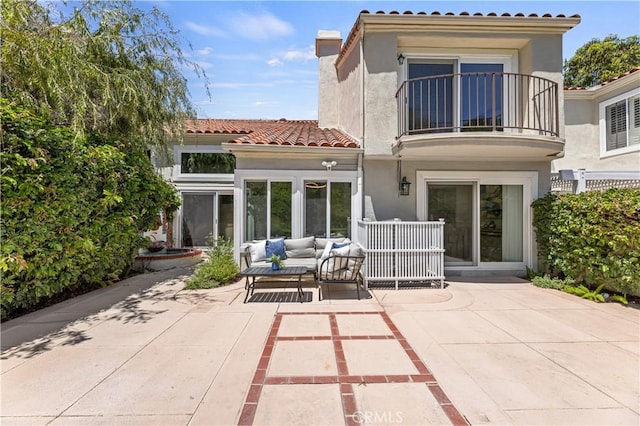 6 Baristo Unit 39, Irvine, CA 92612 - back of house featuring a balcony, a tiled roof, outdoor lounge area, and stucco siding