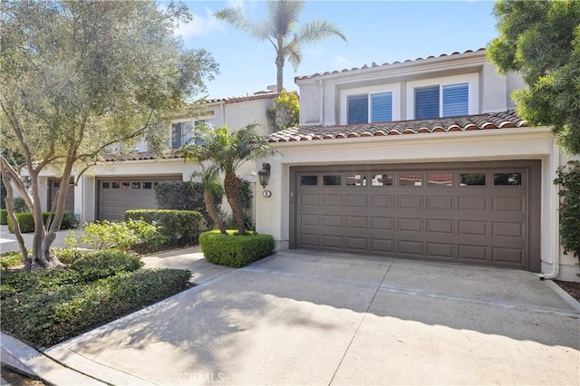 6 Baristo Unit 39, Irvine, CA 92612 - mediterranean / spanish-style home featuring concrete driveway, stucco siding, and an attached garage