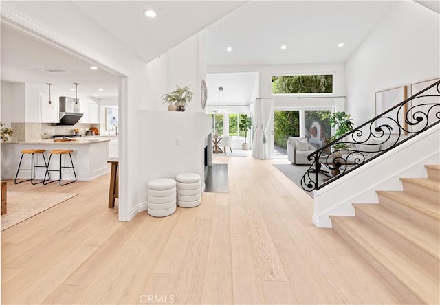 6 Baristo Unit 39, Irvine, CA 92612 - foyer entrance with light wood finished floors, recessed lighting, stairs, and a fireplace