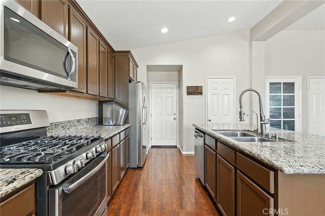 31969 Frontier Manor St, Menifee, CA 92584 - kitchen with appliances with stainless steel finishes, light stone countertops, a center island with sink, dark wood-type flooring, and recessed lighting