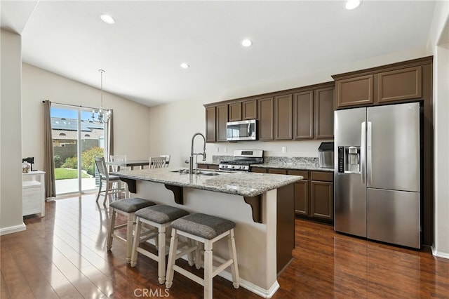 31969 Frontier Manor St, Menifee, CA 92584 - kitchen featuring stainless steel appliances, dark wood-style flooring, lofted ceiling, a kitchen island with sink, and recessed lighting