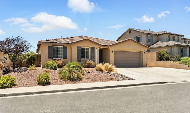 31969 Frontier Manor St, Menifee, CA 92584 - view of front facade featuring stucco siding, an attached garage, concrete driveway, and a tiled roof