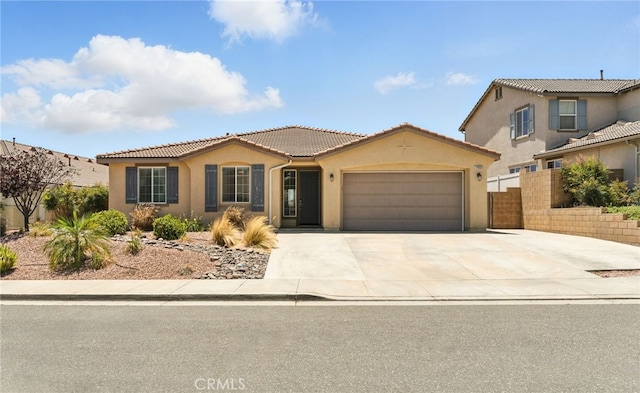 31969 Frontier Manor St, Menifee, CA 92584 - view of front of home with stucco siding, an attached garage, concrete driveway, and a tile roof