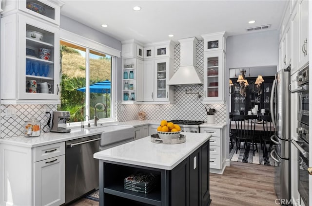 611 Del Dios, San Clemente, CA 92672 - kitchen with stainless steel appliances, premium range hood, open shelves, light countertops, and white cabinets