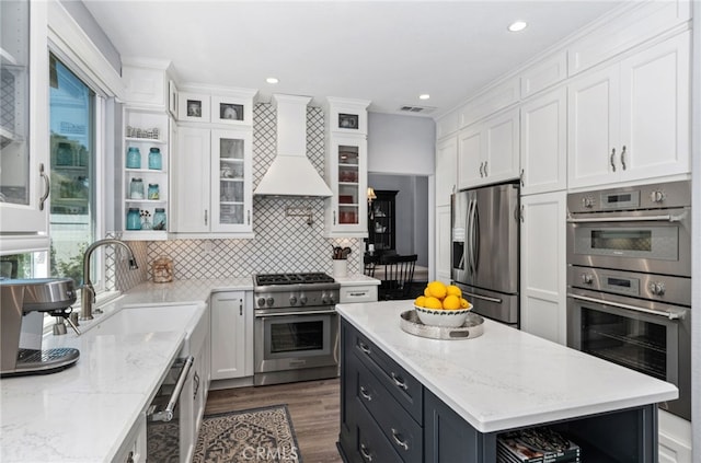 611 Del Dios, San Clemente, CA 92672 - kitchen featuring appliances with stainless steel finishes, white cabinets, custom range hood, dark wood-style flooring, and dark cabinets