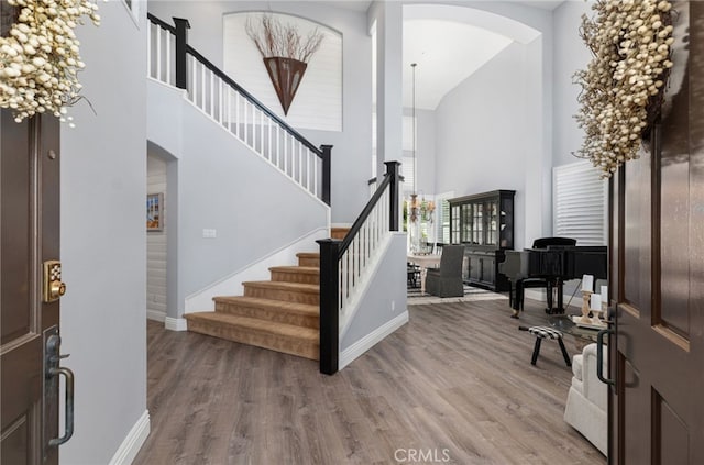 611 Del Dios, San Clemente, CA 92672 - foyer with arched walkways, high vaulted ceiling, wood finished floors, and stairway