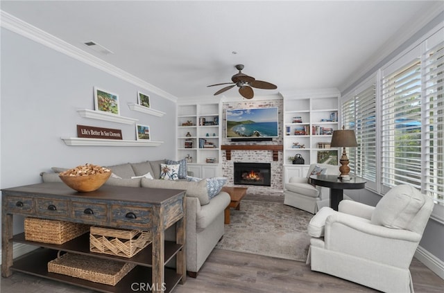 611 Del Dios, San Clemente, CA 92672 - living room featuring ceiling fan, wood finished floors, ornamental molding, a brick fireplace, and built in features