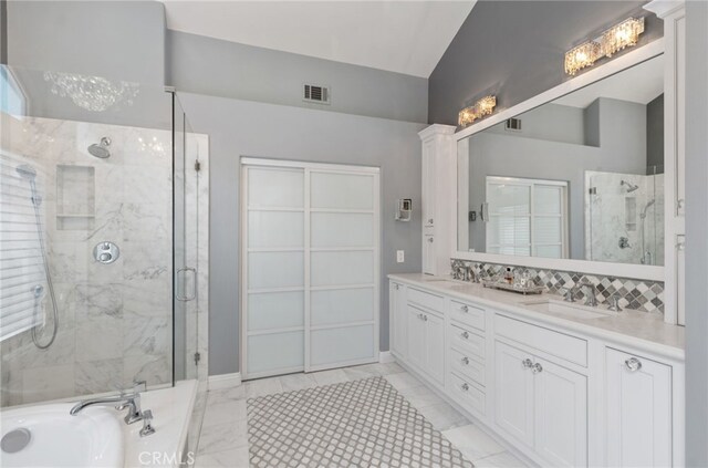 611 Del Dios, San Clemente, CA 92672 - full bathroom with a marble finish shower, double vanity, a bath, vaulted ceiling, and marble finish floors