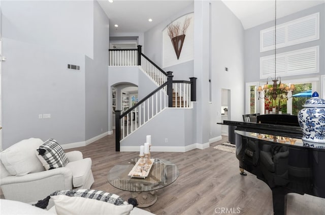 611 Del Dios, San Clemente, CA 92672 - living room with a high ceiling, arched walkways, stairs, wood finished floors, and recessed lighting