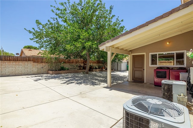 5808 Monterey Pl, Palmdale, CA 93552 - fenced backyard featuring a storage unit, a patio area, and washer / clothes dryer