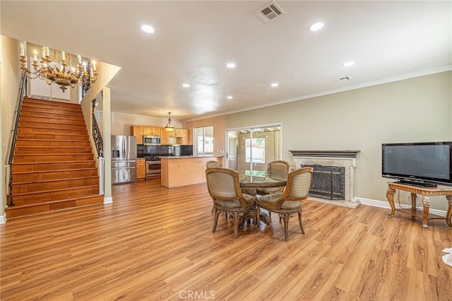 5808 Monterey Pl, Palmdale, CA 93552 - dining room featuring recessed lighting, ornamental molding, light wood-style floors, stairway, and a high end fireplace