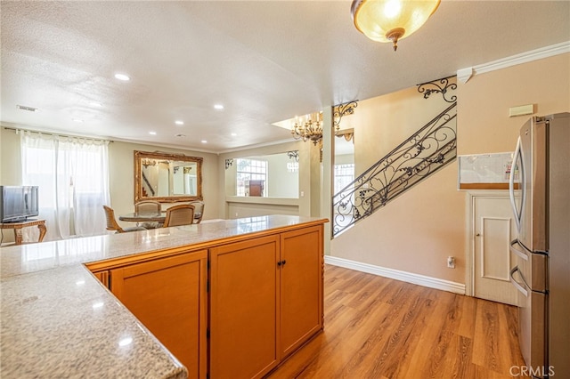 5808 Monterey Pl, Palmdale, CA 93552 - kitchen with freestanding refrigerator, light wood finished floors, crown molding, light countertops, and recessed lighting