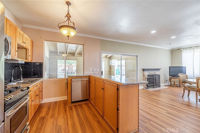 5808 Monterey Pl, Palmdale, CA 93552 - kitchen featuring appliances with stainless steel finishes, light wood-style floors, plenty of natural light, tasteful backsplash, and recessed lighting