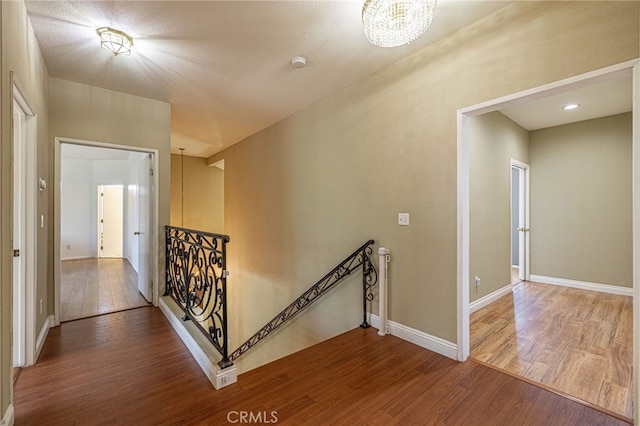 5808 Monterey Pl, Palmdale, CA 93552 - hall with an upstairs landing, wood finished floors, and a chandelier